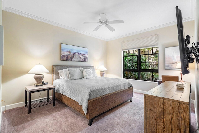 carpeted bedroom with ceiling fan and ornamental molding