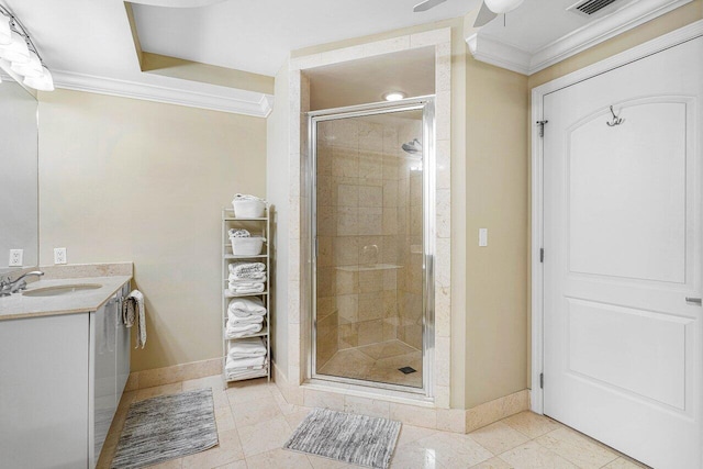 bathroom featuring tile patterned floors, walk in shower, vanity, ceiling fan, and crown molding