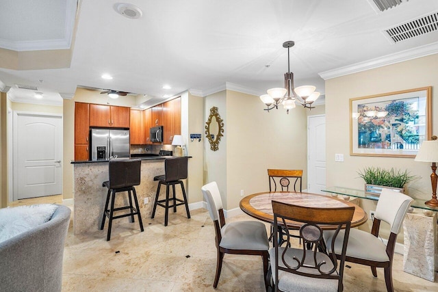 dining room featuring a notable chandelier and ornamental molding