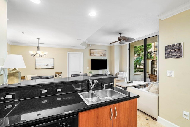 kitchen with ceiling fan with notable chandelier, floor to ceiling windows, crown molding, and sink