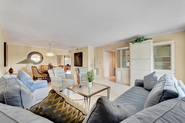 tiled living room with crown molding and a chandelier