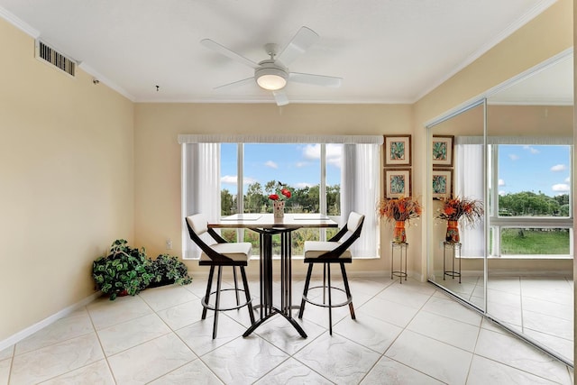 tiled dining area with crown molding, a wealth of natural light, and ceiling fan