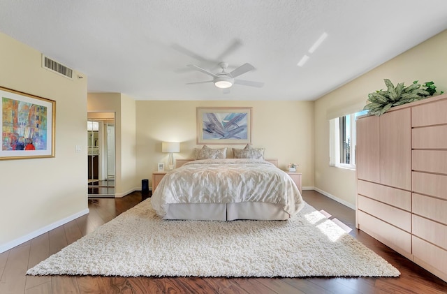 bedroom with ceiling fan and dark hardwood / wood-style flooring