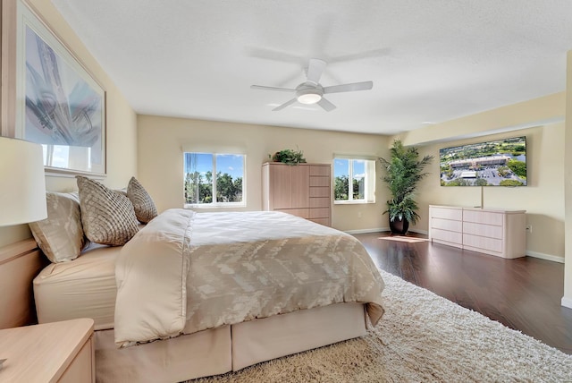 bedroom with dark hardwood / wood-style flooring and ceiling fan