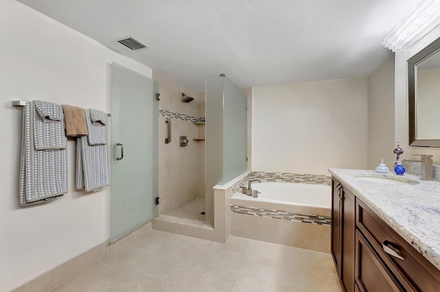 bathroom featuring vanity, tile patterned floors, and separate shower and tub