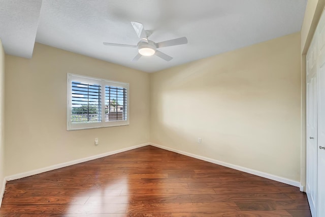 empty room with dark wood-type flooring, a textured ceiling, and ceiling fan