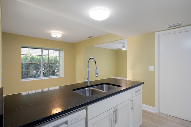 kitchen with ceiling fan, white cabinetry, white dishwasher, light hardwood / wood-style flooring, and sink