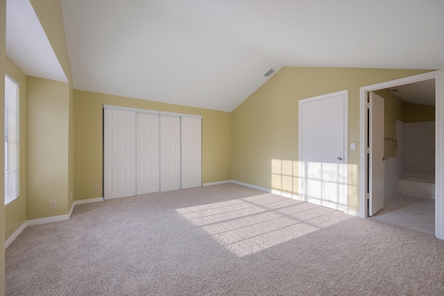 additional living space featuring vaulted ceiling and carpet floors