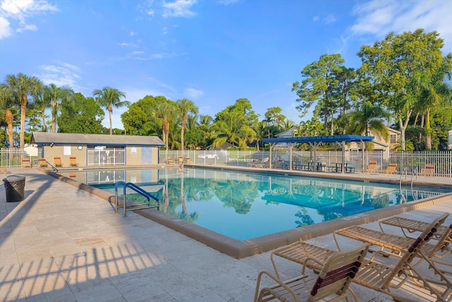 view of swimming pool with a patio area and an outdoor structure