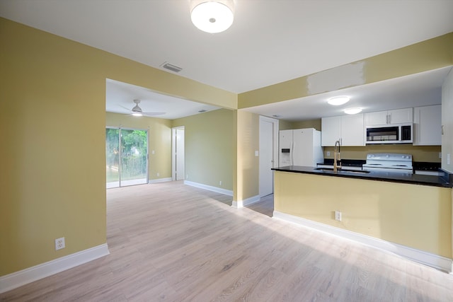 kitchen with white cabinets, ceiling fan, light hardwood / wood-style floors, sink, and white appliances