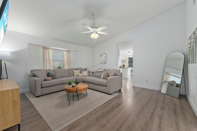 living room featuring ceiling fan, wood-type flooring, and lofted ceiling