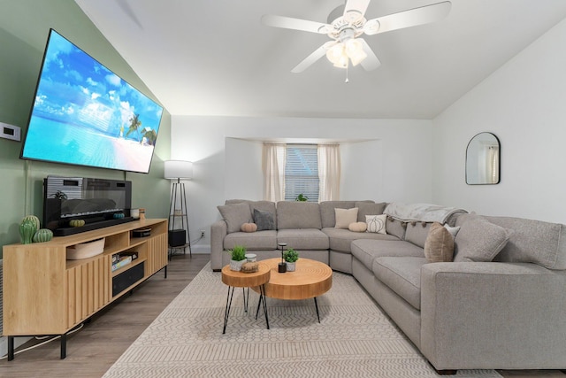 living room with hardwood / wood-style floors, ceiling fan, and lofted ceiling