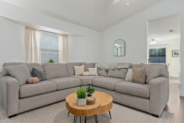 living room featuring ceiling fan and lofted ceiling