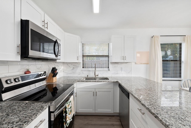 kitchen featuring white cabinetry, sink, plenty of natural light, and appliances with stainless steel finishes