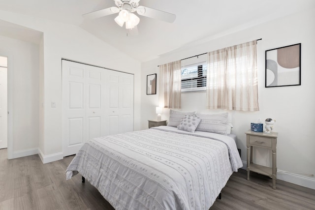 bedroom featuring a closet, hardwood / wood-style flooring, ceiling fan, and lofted ceiling