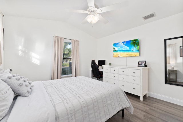 bedroom with ceiling fan, wood-type flooring, and vaulted ceiling