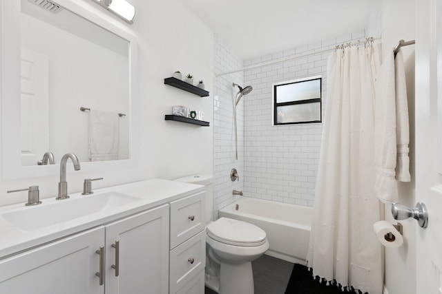 full bathroom featuring vanity, shower / bath combo, and toilet