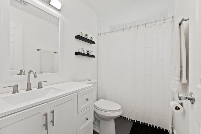 bathroom featuring vanity and toilet