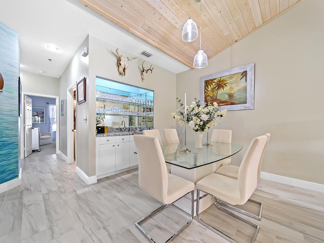 dining area featuring wood ceiling and vaulted ceiling