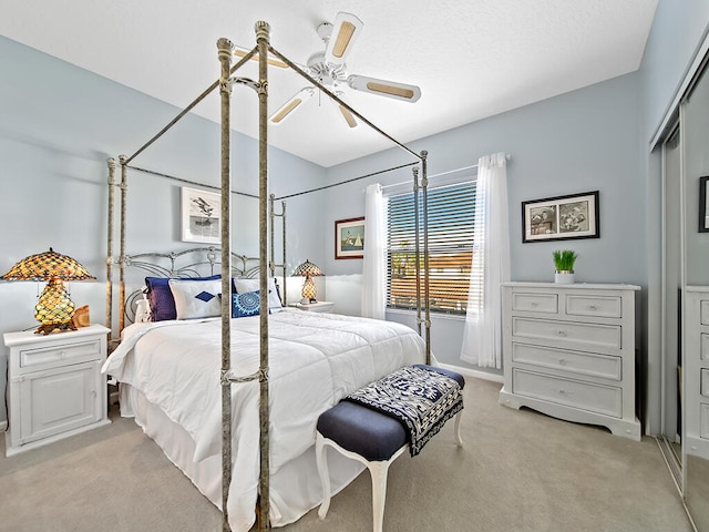 carpeted bedroom with a closet and ceiling fan