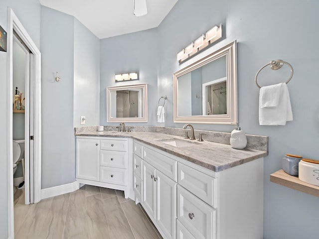 bathroom featuring vanity and toilet