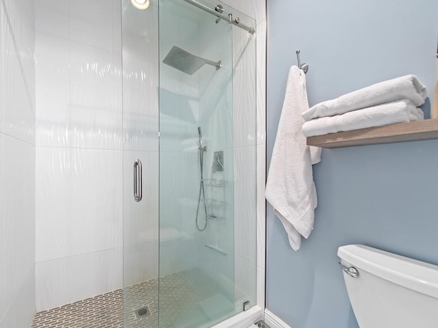 bathroom with toilet and walk in shower