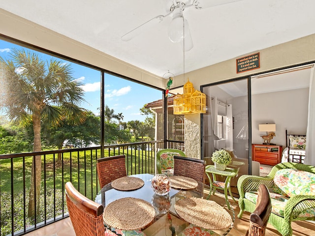 sunroom / solarium featuring ceiling fan