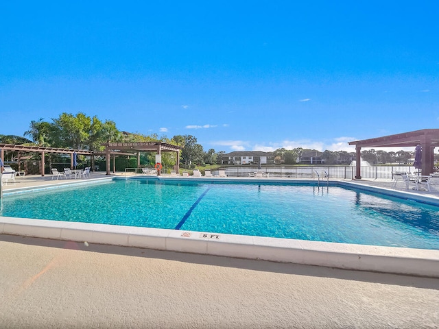 view of swimming pool featuring a patio and a pergola