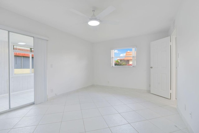 empty room featuring ceiling fan and light tile patterned floors