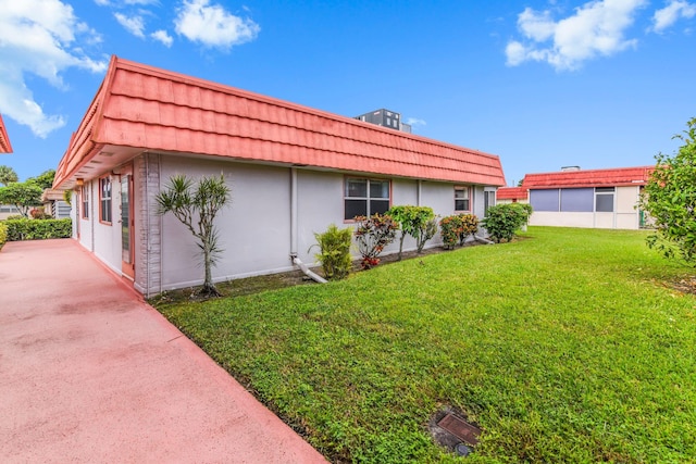 view of side of property with a lawn