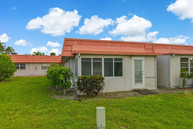 rear view of property with a lawn