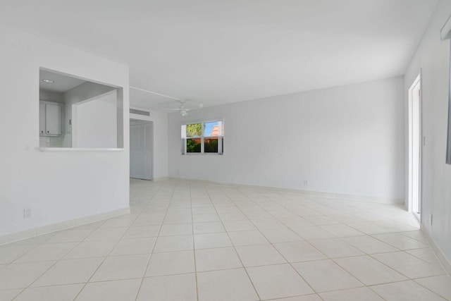 empty room featuring light tile patterned floors and ceiling fan