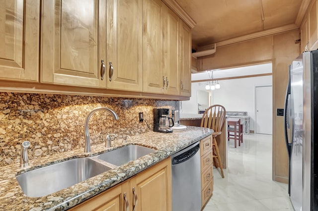 kitchen with appliances with stainless steel finishes, light brown cabinets, sink, and light stone counters