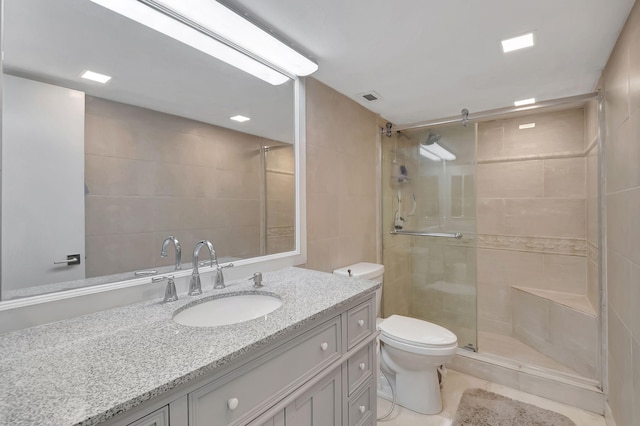 bathroom with vanity, tile patterned flooring, toilet, and walk in shower