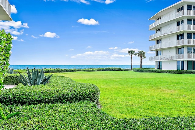 view of yard featuring a balcony and a water view