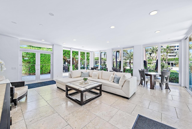 living room with floor to ceiling windows, french doors, and a healthy amount of sunlight