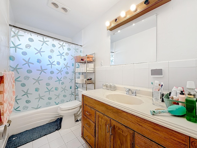 full bathroom featuring tile patterned flooring, shower / bath combination with curtain, vanity, toilet, and tile walls