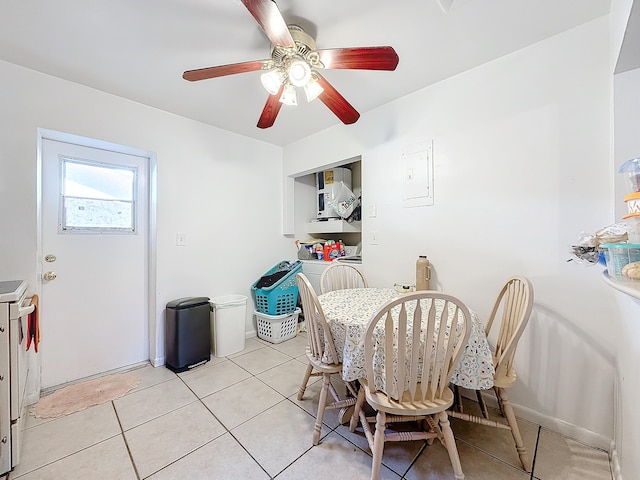 dining space featuring light tile patterned flooring and ceiling fan