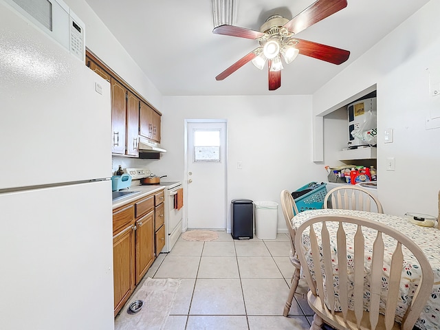 kitchen with light tile patterned floors, white appliances, and ceiling fan