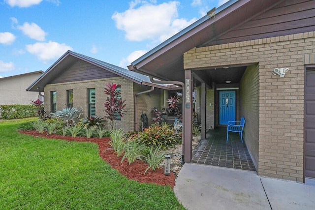 doorway to property with a yard and a garage