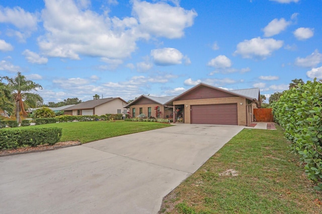 ranch-style home with a front lawn and a garage