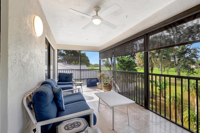 sunroom / solarium featuring ceiling fan