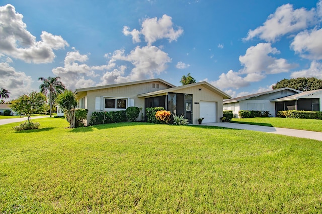 ranch-style house with a garage, driveway, a front yard, and a sunroom