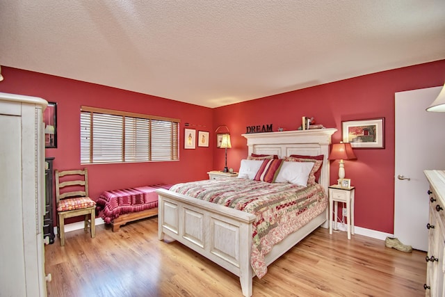 6357 Stanley Ln, Delray Beach, FL 33484 - bedroom featuring light wood-style floors, baseboards, and a textured ceiling