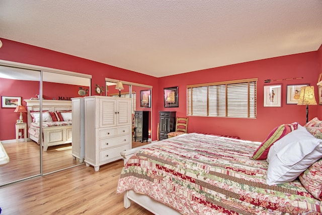 6357 Stanley Ln, Delray Beach, FL 33484 - bedroom with light wood finished floors and a textured ceiling