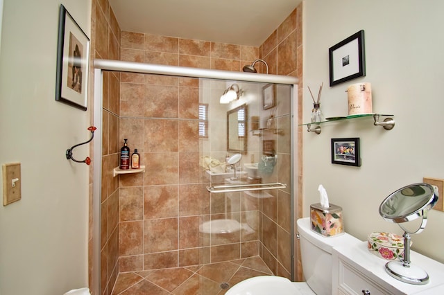 bathroom with a shower with shower door and toilet