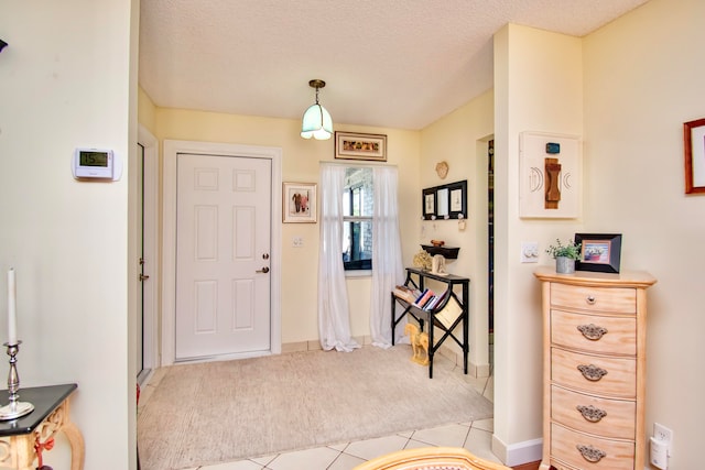 tiled entrance foyer with a textured ceiling