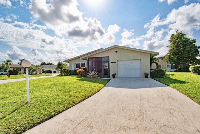 6357 Stanley Ln, Delray Beach, FL 33484 - single story home with an attached garage, concrete driveway, and a front lawn