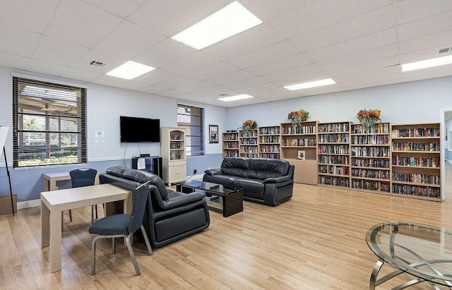 6357 Stanley Ln, Delray Beach, FL 33484 - living area featuring light wood-type flooring, a paneled ceiling, and baseboards