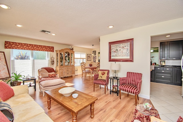 6357 Stanley Ln, Delray Beach, FL 33484 - living room featuring light wood-type flooring, recessed lighting, and a textured ceiling